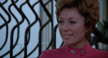 Movie still from “Joe” (1970), directed by John G. Avildsen – A person wearing a suit and smiling; Close Up shot, Low angle