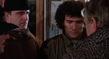 Movie still from “Joe” (1970), directed by John G. Avildsen – A man in a military jacket and a woman in a military jacket; Close Up shot, Over the shoulder angle