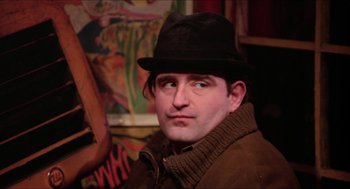 Movie still from “Joe” (1970), directed by John G. Avildsen – A person wearing a hat and a jacket; Close Up shot, Over the shoulder angle