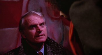 Movie still from “Joe” (1970), directed by John G. Avildsen – An older man wearing a suit and tie looking up; Close Up shot, Over the shoulder angle