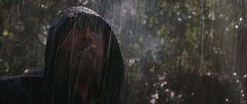 Movie still from “Joe” (2013), directed by David Gordon Green – A man with a beard is smoking in the rain; Close Up shot, Low angle