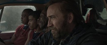 Movie still from “Joe” (2013), directed by David Gordon Green – A group of people sitting in a car; Close Up shot, Over the shoulder angle