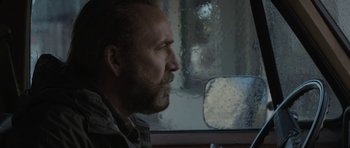 Movie still from “Joe” (2013), directed by David Gordon Green – A man looking out of a car window; Close Up shot, Over the shoulder angle