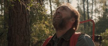 Movie still from “Joe” (2013), directed by David Gordon Green – A man with a beard looking up into the sky; Close Up shot, Low angle