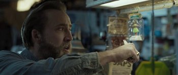 Movie still from “Joe” (2013), directed by David Gordon Green – A bearded man holding something in his hand; Close Up shot, Low angle