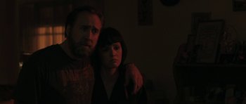 Movie still from “Joe” (2013), directed by David Gordon Green – A man and a woman standing next to each other in a dark room; Close Up shot, Over the shoulder angle