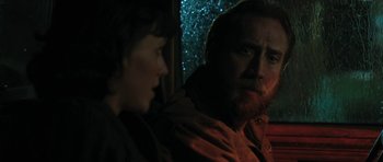 Movie still from “Joe” (2013), directed by David Gordon Green – A man and a woman looking at each other in the rain; Close Up shot, Over the shoulder angle