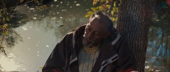 Movie still from “Joe” (2013), directed by David Gordon Green – An old man with a beard and a jacket on; Medium shot, High angle