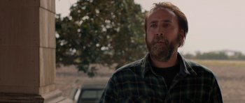 Movie still from “Joe” (2013), directed by David Gordon Green – A person wearing a plaid shirt; Close Up shot, Over the shoulder angle