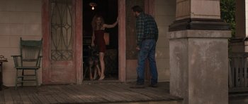 Movie still from “Joe” (2013), directed by David Gordon Green – A man and a woman standing in front of an open door; Wide shot, Over the shoulder angle