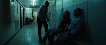 Movie still from “Joe” (2013), directed by David Gordon Green – Two men sitting in a room next to each other; Wide shot, Over the shoulder angle