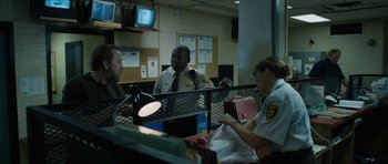 Movie still from “Joe” (2013), directed by David Gordon Green – A group of people sitting at a table; Medium shot, Over the shoulder angle