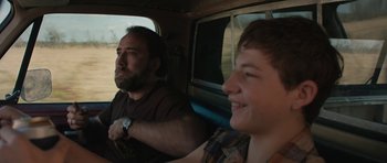 Movie still from “Joe” (2013), directed by David Gordon Green – A man and a boy sitting in the back of a car; Close Up shot, Over the shoulder angle