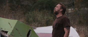 Movie still from “Joe” (2013), directed by David Gordon Green – A man standing in front of a green plane; Close Up shot, Low angle