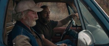 Movie still from “Joe” (2013), directed by David Gordon Green – Two men sitting in the drivers seat of a car; Medium shot, Over the shoulder angle