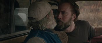 Movie still from “Joe” (2013), directed by David Gordon Green – A man with a beard and a hat is looking at another man with a beard; Close Up shot, Over the shoulder angle