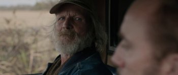 Movie still from “Joe” (2013), directed by David Gordon Green – An older man with a beard and a hat; Close Up shot, Over the shoulder angle