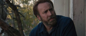 Movie still from “Joe” (2013), directed by David Gordon Green – A man with a goatee and a beard looking to his left; Close Up shot, Over the shoulder angle