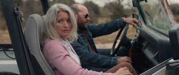 Movie still from “Joe” (2013), directed by David Gordon Green – A man and a woman driving a car in the road; Close Up shot, Over the shoulder angle