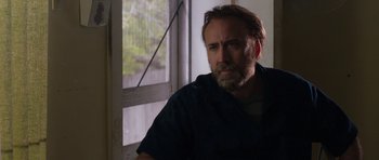 Movie still from “Joe” (2013), directed by David Gordon Green – A man sitting in front of a window looking sad; Close Up shot, Over the shoulder angle