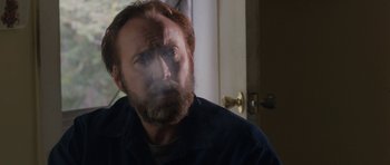 Movie still from “Joe” (2013), directed by David Gordon Green – A man with a goatee is looking at the camera; Close Up shot, Over the shoulder angle