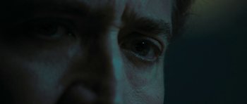 Movie still from “Joe” (2013), directed by David Gordon Green – A man's eyes with a dark background; Extreme Close Up shot, Low angle