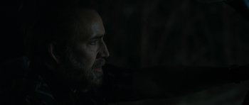 Movie still from “Joe” (2013), directed by David Gordon Green – A man with a goatee is looking into the distance; Close Up shot, Over the shoulder angle