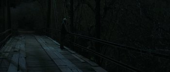 Movie still from “Joe” (2013), directed by David Gordon Green – An old man standing on a bridge at night; Wide shot, High angle