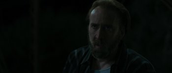 Movie still from “Joe” (2013), directed by David Gordon Green – A person with a beard looking at the camera; Close Up shot, Over the shoulder angle