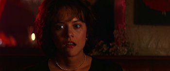 Movie still from “Joe Versus the Volcano” (1990), directed by John Patrick Shanley – A person wearing a necklace; Close Up shot, Over the shoulder angle