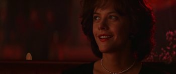 Movie still from “Joe Versus the Volcano” (1990), directed by John Patrick Shanley – A person wearing a necklace; Close Up shot, Low angle