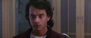 Movie still from “Joe Versus the Volcano” (1990), directed by John Patrick Shanley – A person with long black hair; Close Up shot, Over the shoulder angle