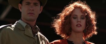 Movie still from “Joe Versus the Volcano” (1990), directed by John Patrick Shanley – A man and a woman standing next to each other; Close Up shot, Low angle