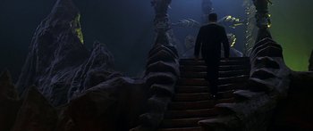 Movie still from “Joe Versus the Volcano” (1990), directed by John Patrick Shanley – A man walking down a set of stairs; Extreme Wide shot, High angle