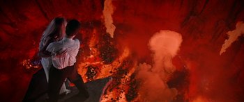 Movie still from “Joe Versus the Volcano” (1990), directed by John Patrick Shanley – A man standing in front of a wall of fire; Extreme Wide shot, Overhead angle