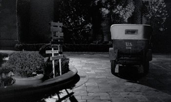 Movie still from “Johnny Got His Gun” (1971), directed by Dalton Trumbo – A black and white photo of a street corner; Wide shot, High angle
