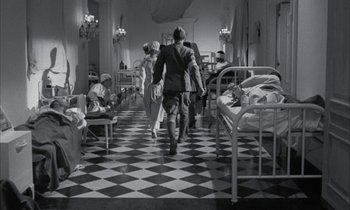 Movie still from “Johnny Got His Gun” (1971), directed by Dalton Trumbo – A black and white photo of people in a hospital; Wide shot, High angle