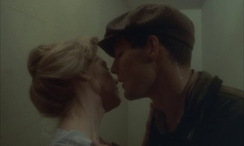 Movie still from “Johnny Got His Gun” (1971), directed by Dalton Trumbo – A man and a woman kissing each other in front of a mirror; Close Up shot, Low angle