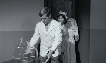 Movie still from “Johnny Got His Gun” (1971), directed by Dalton Trumbo – A man and a woman standing next to each other in a room; Medium shot, Low angle