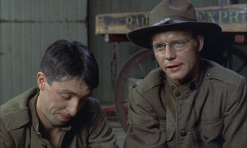 Movie still from “Johnny Got His Gun” (1971), directed by Dalton Trumbo – Two men in military uniforms sitting next to each other; Close Up shot, Over the shoulder angle