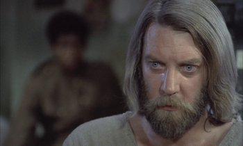 Movie still from “Johnny Got His Gun” (1971), directed by Dalton Trumbo – A person with long hair and a beard; Close Up shot, Low angle