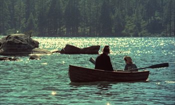 Movie still from “Johnny Got His Gun” (1971), directed by Dalton Trumbo – Two people are in a canoe on a lake; Extreme Wide shot, High angle