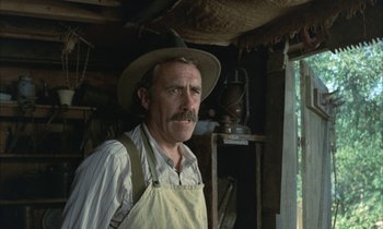 Movie still from “Johnny Got His Gun” (1971), directed by Dalton Trumbo – An older man wearing an apron and a hat; Close Up shot, Low angle