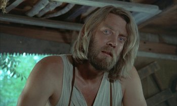 Movie still from “Johnny Got His Gun” (1971), directed by Dalton Trumbo – A person with long hair and a beard; Close Up shot, Low angle