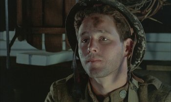 Movie still from “Johnny Got His Gun” (1971), directed by Dalton Trumbo – A man in a military uniform with a hat on his head; Close Up shot, High angle