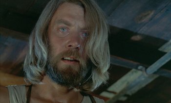 Movie still from “Johnny Got His Gun” (1971), directed by Dalton Trumbo – A person with long hair and a beard; Close Up shot, Low angle
