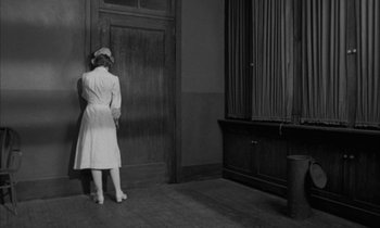 Movie still from “Johnny Got His Gun” (1971), directed by Dalton Trumbo – An old photo of a woman standing in front of an open door; Wide shot, Low angle