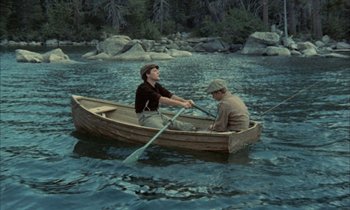 Movie still from “Johnny Got His Gun” (1971), directed by Dalton Trumbo – Two men are in a small wooden boat in the water; Wide shot, High angle