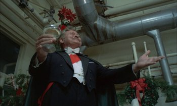 Movie still from “Johnny Got His Gun” (1971), directed by Dalton Trumbo – An older man in a tuxedo holding a glass of wine; Medium shot, Low angle