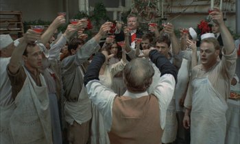 Movie still from “Johnny Got His Gun” (1971), directed by Dalton Trumbo – A group of people standing around each other holding up cellphones; Wide shot, High angle